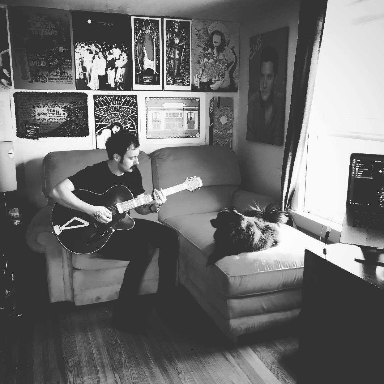 Lucas Frazier playing guitar and serenading his dog